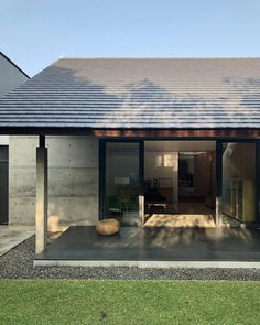 a modern house with an open patio and sliding glass doors