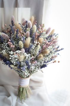 a bouquet of flowers sitting on top of a white cloth