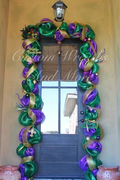 the front door is decorated with purple and green ribbons