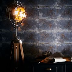 a table lamp sitting on top of a wooden stand next to a piece of paper