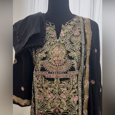 Kurti Kamezz Zari Embroidery With Stone Work Pants With Dupatta Size:43 Condition: Brand New Fitted Black Kurta With Floral Embroidery, Black Embroidered Fabric For Designer Wear During Eid, Black Salwar Kameez With Dabka Work For Transitional Season, Black Salwar Kameez With Dabka Work For Spring/fall, Black Sharara With Intricate Embroidery For Navratri, Transitional Black Salwar Kameez With Dabka Work, Black Churidar With Dabka Work For Transitional Season, Anarkali Embroidered Black Sharara, Traditional Black Sharara With Dabka Details