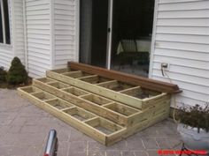 an outdoor patio with steps made out of wood