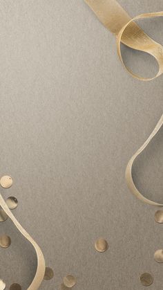 an abstract background with gold ribbons and confetti on the bottom right corner, as well as circles in the middle