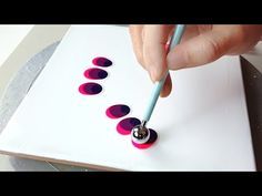 someone is painting circles on a piece of paper