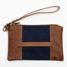 Stylish and durable, this Eastport Clutch is made to accompany you on all of your travels. Perfect for those on the go! Attach the Eastport Clutch to the inside of the Saco River tote Bag or the Fore Street Tote Bag (sold separately) to make a stylish set. Due to the nature of the leather, variations in color may occur. Made in a solar-powered workshop in Maine. Includes detachable leather wrist strap with a bronze lobster clasp built-in leather hand clutch strap zip-top closure Materials waxed Hand Clutch, Navy And Brown, Waxed Canvas, Solar Powered, Leather Purse, Zip Top, Wrist Strap, Full Grain Leather, Fabric Patterns