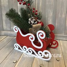 a wooden sleigh with christmas decorations on it