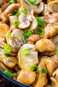 chicken and mushrooms with green onions in a skillet