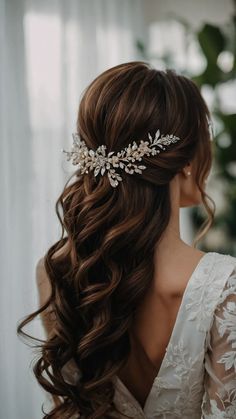 a woman wearing a bridal hair comb with flowers in it's back half - up