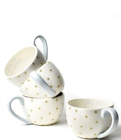 three coffee cups stacked on top of each other with gold stars painted on the sides