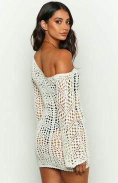 * White Crochet Long Sleeve Mini Dress 
 * 
 
 * HOW TO STYLE: 
 * Go for an off the shoulder look in this stunning crochet mini dress (). Loving this asymmetrical neckline - be sure to style with gold jewellery () and sandals for the perfect beachside vacation () outfit. 
 * 
 
 * FEATURES: 
 * Mini Length 
 * One shoulder style 
 * Long sleeves 
 * Slight stretch 
 * Pull on style 
 * Crochet knit material 
 * Unlined 
 * Sheer 
 * Mid-weight crochet material Long Sleeve Crochet Top For Summer Parties, Off-shoulder Mini Dress For Beach, Spring Mini Dress With Crochet Detailing, Mini Beach Cover-up Dress With Hollow Out Details, Mini Beach Cover-up Dress With Hollow Out, Off-shoulder Mini Dress For Beach Season, Fitted Hollow Out Mini Dress For Beach Cover-up, Crochet Summer Mini Dress, Spring Party Mini Dress With Crochet Details