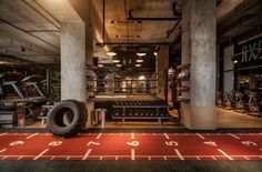 a large tire sitting on top of a red rug in a room filled with machines