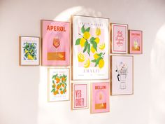 a bunch of posters on the wall with lemons and oranges hanging from them