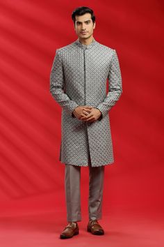 Top Details Color- GREY, Fabric - Suiting Fabric With Embroidered Bottom Details Color- Grey, Fabric -Suiting Fabric, Style - Pant Package Include :INCLUDES 1 SHERWANI,1 PANT. Turban ,Mojari And Other Accessories Are Not Sold Along With The Dress. CARE: DRY CLEAN ONLY Additional Information : - As This Sherwani/Waistcoat/Kurta Are Made As Per Orders So It Is Strictly Not Acceptable Once Get Delivered .So Kindly Choose Body Fit Size . Also We Keep 2 Inches Extra Margin In The Dress. Gray Traditional Wear For Festive Occasions, Gray Festive Traditional Wear, Festive Gray Traditional Wear, Semi-stitched Gray Traditional Wear With Zari Work, Silver Traditional Wear With Intricate Embroidery For Eid, Silver Traditional Wear With Intricate Embroidery For Festive Season, Festive Silver Traditional Wear With Intricate Embroidery, Traditional Silver Kurta For Wedding, Bollywood Style Silver Kurta For Wedding