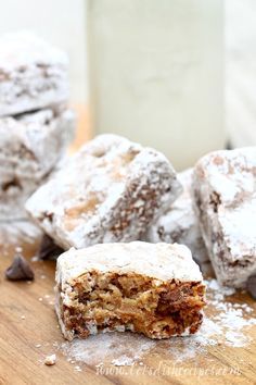 chocolate graham bars are stacked on top of each other with powdered sugar around them