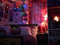 a bedroom decorated with lights and pictures on the wall above the bed, along with bookshelves