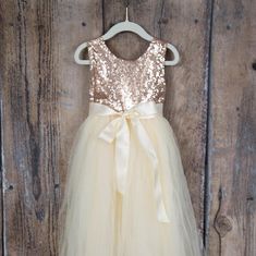 One of our best sellers! This dress is just beautiful...haven’t you heard?! Rose gold is the color of the year! It is a beautiful shade of ivory/cream tulle on the bottom. The rose gold sequin top add a fun, elegant feel while the full tulle bottom is a little girls dream! It also has an Cream Flower Girl Dress, Rose Gold Sequin Top, Sequins Wedding Gown, Gold Sequin Top, Ivory Flower Girl, Ivory Flower Girl Dresses, Tulle Flower Girl, Sequin Wedding, Tulle Flowers