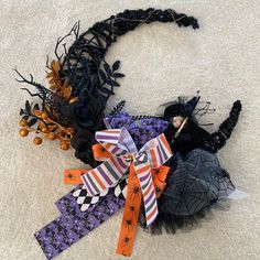 two halloween decorations are laying on the floor next to each other and one is wearing a witch costume