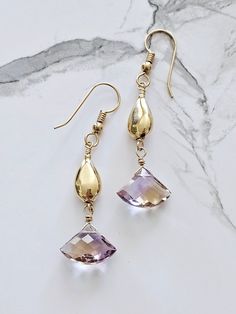 Beautiful natural Ametrine dangling from gold filled beads.  Ametrine is a combination of amethyst and citrine within one stone.  All the known ametrine had been mined so the only stones available are those already on the market - a difficult and expensive stone to find.    For me, creating jewelry is creating art I never create the same piece twice.   Ametrine combines and amplifies the benefits of chakras - the citrine (solar plexus) and crown (amethyst); citrine increases focus aided by the inspiration of amethyst. Don't lose your earrings!  Ear nuts are included with purchase. Gold Amethyst Drop Earrings, Gold Amethyst Gemstone Crystal Earrings, Gold Amethyst Crystal Earrings With Gemstone, Handmade Amethyst Crystal Earrings In Gold, Gold Amethyst Crystal Earrings, Gold Amethyst Long Drop Earrings, Gold Amethyst Earrings With Gemstone Accents, Ametrine Earrings, Expensive Stones