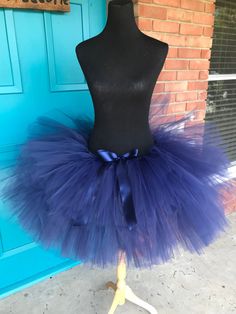 a mannequin wearing a purple and blue tutu