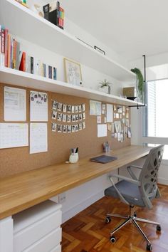 an office with a desk, chair and bookshelf on the wall above it