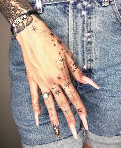 a woman's hand with tattoos on it