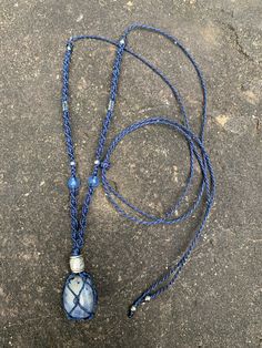 Macramé net necklace containing a natural fine stone. 1- white agate, braiding with black and brown waxed thread, recycled paper beads* and wood beads. 2- Sodalite, braiding with blue waxed thread, blue agate beads and silver metal beads. 3- Tiger's eye, braiding with black waxed thread, agate beads, wood and a bronze metal bead. The necklace is hand braided and unique. The cord is adjustable, so the collar can be worn short or long if desired. *These unique beads are made by abandoned widows and wives in remote villages in Uganda. Long triangular strips of paper are cut and wrapped by hand around a needle to form the pearl. They are then soaked in a sealant, which makes them water resistant and gives the pearls their glossy finish. The money earned by women ensures the education of their Adjustable Bohemian Necklace With Silk Cord, Bohemian Necklace With Adjustable Silk Cord, Unique Blue Macrame Jewelry, Bohemian Silk Cord Adjustable Necklaces, Bohemian Adjustable Silk Cord Necklace, Handmade Adjustable Silk Cord Necklaces, Bohemian Blue Jewelry With Adjustable Cord, Artisan Macrame Necklace With Waxed Cord, Blue Spiritual Macrame Jewelry