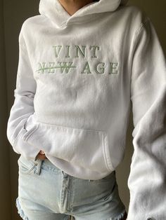 "Comfy and cozy upcycled vintage white champion hoodie featuring a \"Vint Age\"  logo embroidered by local BIPOC woman-owned small business. By purchasing this item, you are supporting TWO small businesses and saving a piece of clothing from potentially ending up in a landfill or incinerator while receiving a one-of-a-kind item!  80% cotton | 30% polyester Tag reads: Champion | Made in Canada Recommended for size S-L depending on desired drape & styling but please always refer to measurements to Spring Vintage Hoodie With Relaxed Fit, Vintage Relaxed Fit Hoodie For Spring, White Hoodie With Embroidered Text For Fall, White Embroidered Hoodie For Fall, White Hoodie With Embroidered Text For College, White Sporty Hoodie With Letter Embroidery, Sporty White Hoodie With Letter Embroidery, Vintage Embroidered Text Sweatshirt For Winter, White Hoodie With Embroidered Graphics In Relaxed Fit