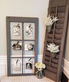 an old ladder is used as a shelf for photos and vases with flowers in them