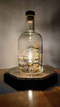 an empty bottle sitting on top of a wooden table