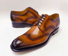 Calfskin Wingtip Oxford Caramel Completely Handmade, this stunning Burnished Calfskin lace-up Wingtip Blucher Oxford from the Ugo Vasare collection features Goodyear Welted construction, Brogue design: decorative perforations with a toe medallion, a wheeled welt and a leather sole! Wide Sizes Available. Don't see your size? Call us to place a Special Order in your size. Cordovan Shoes, Shoe Horn, Wingtip Oxford, Shoe Tree, Goodyear Welt, Horse Hair, Suede Shoes, Shoe Box, New Shoes