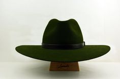 "Wide Brim Fedora | The PUNTER | Styled and finished by hand Customize it to match your physical characteristics and lifestyle. Personalize it to reflect your unique statement. At a glance: - Available in any color combination from our swatches - Tried and true handmade quality - Fits your exact head measurement comfortably - Delivered safely inside a real hat box - Includes a protective organic cotton drawstring bag - Comes with care instructions - Three delivery options Specifications: - Class Green Military Brimmed Hat, Green Military Hat With Curved Brim, Green Military Hat With Wide Brim, Green Wide Brim Military Hat, Green Military Style Wide Brim Hat, Green Fedora With Flat Brim For Outdoor, Green Flat Brim Fedora For Outdoor, Military Style Hat With Short Brim, Real Hat