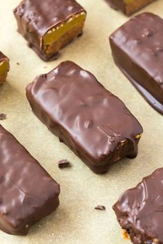 chocolate covered pieces of cake sitting on top of a table