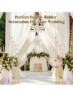 an outdoor wedding ceremony with white drapes and floral arrangements on the altar, surrounded by candles