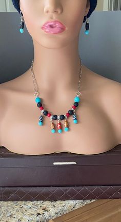 Unique Turquois, Red Agate, Black Lava Rock, and Bone Necklace and Earrings on Stainless Steel Chain, Five Colorful Pendants Hanging from the Basic Lava Rock and Agate Necklace, Matching Dangle Stainless Steel Earrings with Wood and Turquois Beads, Adjustable Chain with Large Stainless Steel Lobster Claw Clasp, Hypoallergenic, Three Gemstone Necklace, Just in Time for Festival Season, Gifts for Ladies and Men, Gifts for Girls and Boys, 20-inch Chain Adjustable down to 15 inches, Ho-Bo, Hippie, Handmade Eclectic Red Jewelry, Adjustable Eclectic Red Jewelry, Multicolor Southwestern Beaded Chain Jewelry, Multicolor Southwestern Style Beaded Chain Jewelry, Eclectic Beaded Dangle Jewelry, Southwestern Multicolor Beaded Jewelry, Southwestern Multicolor Beaded Chain Jewelry, Southwestern Style Multicolor Beaded Chain Jewelry, Eclectic Adjustable Dangle Jewelry