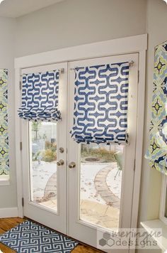 an advertisement for french doors with blue and white patterns on the front door, which is open