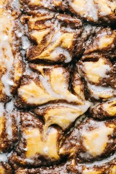 a close up view of cinnamon rolls covered in icing