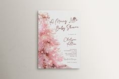 a baby shower with pink flowers on the front and back of it's card