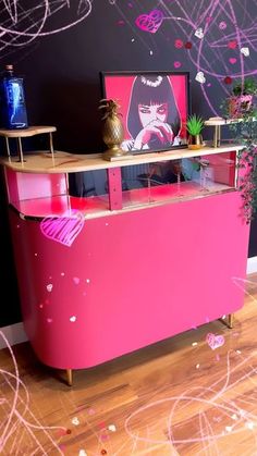 a pink counter in front of a black wall