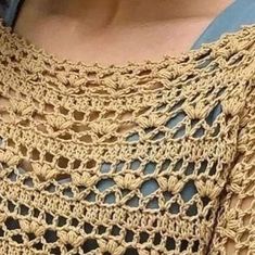 a woman is wearing a crocheted top with an openwork design on it