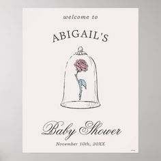 a baby shower sign with a pink rose in a glass bell on it's side