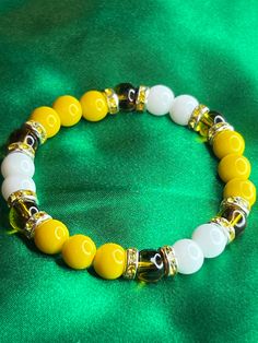 Yellow Honey Bee inspired beaded bracelet with sliver and yellow accents 7.5 in or 19.05 cm Strong, Stretchy, and Durable     Very pretty bracelet for any occasion for any day Yellow Stretch Bracelet With Faceted Beads For Gift, Adjustable Yellow Faceted Beads Stretch Bracelet, Yellow Bracelets With Colorful Round Beads, Yellow Bracelets With Colorful Beads, Yellow Beaded Stretch Bracelet With Round Beads, Yellow Beaded Stretch Bracelet, Yellow Beaded Bracelets As Gift, Yellow Stretch Bracelet With Round Beads As Gift, Casual Yellow Beaded Bracelets With 8mm Beads