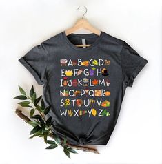 "Thanksgiving Alphabet Shirt, Thanksgiving Teacher Shirt, Thankful Teacher Shirt, Thanksgiving Gift For Teacher, Thanksgiving Vibes Shirt 🎈HOW TO ORDER 1-) Please, check and review all the photos. 2-) Choose your t-shirt size and color. *Different styles of shirts may have different shades of same color choice due to different manufacturer brands. *For this reason, we recommend you to match shirts from the same styles if you want precisely matching colors (ex. Unisex, V-necks, Toddler, etc.). 3 Teacher Thanksgiving Shirts, Multicolor Short Sleeve Shirt For Fall, Thanksgiving Teacher Shirts, Thanksgiving Alphabet, Thanksgiving Wallpapers, Thanksgiving Vibes, Teacher Thanksgiving, Teachers Thanksgiving, Teacher Board