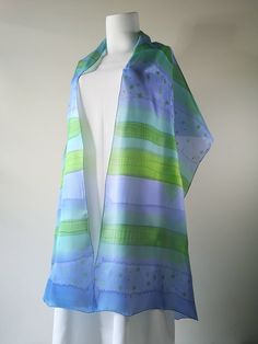 ", silk wrap blue, silk scarf, personalized gift for woman, original silk art accessory  I created this long silk shawl using the freehand painting technique, using blue, green, and turquoise shades spilled color lines on white silk with a touch of gold. Colors blend freely into each other and create a subtle shining pattern with the mood of a clear summer sky. Small drops of gold on the smooth surface of the scarf make an impression of golden mist and a sense of luxury. This cool silk wrap is a Elegant Hand Painted Blue Silk Scarf, Blue Silk Scarf For Spring, Elegant Blue Hand Painted Scarves, Blue Satin Silk Scarf As Gift, Elegant Hand Painted Blue Scarves, Blue Satin Silk Scarf For Gift, Summer Blue Silk Scarf, Blue Hand Painted Silk Scarf, Hand Painted Blue Silk Scarf For Gift