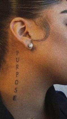 a woman's ear with the words purpose written on it