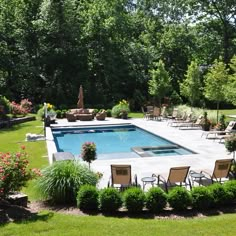 an empty swimming pool surrounded by lawn chairs