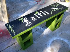 a bench with the word faith painted on it