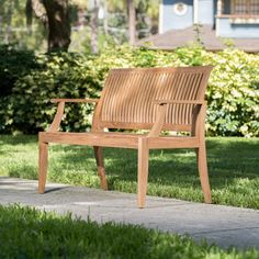 a wooden bench sitting on top of a sidewalk