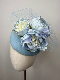 A gorgeous blue felt fascinator featuring a cluster of beautiful artificial ombré blue peonies and Pearl centres and matching veil. This beautiful fascinator sits on an elastic hat band. This classic fascinator is perfect for any formal occasion, weddings and races. Brand New. The felt fascinator measures approximately 15cm in diameter. If you need your item by a certain date please let me know. Made in the UK. Custom orders are welcome. Many more items are available in our Shop. Returns Please notify us within 3 days of receiving your item if you intend to return it. We allow 7 days from the date of receipt of the headpiece to return it to us, our returns requirements are that it is returned properly packaged to prevent damage in the post, it is unworn/as new condition and has not had the Light Blue Fascinator, Spring Blue Mini Hats With Handmade Flowers, Light Blue Headpieces For Spring Wedding, Blue Headpieces For Spring Weddings, Blue Fitted Headpiece With Handmade Flowers, Blue Wedding Fascinator With Handmade Flowers, Felt Fascinator, Blue Fascinator, Blue Peonies