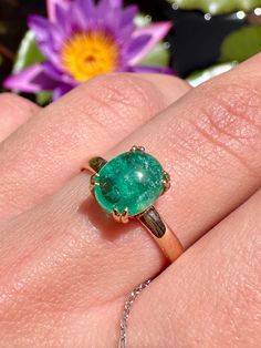 Colombian Emerald Ring Certificate by AIG #J3410127018 14k Rose Gold 2.95g  Natural Colombian Emerald 1.56ct Size - 7 Immerse yourself in the captivating allure of this certified 1.56ct Colombian emerald ring, crafted in shimmering 14k rose gold. The emerald, boasting vibrant green hues and exceptional clarity, is certified by the renowned AIG (#J3410127018), guaranteeing its authenticity and natural origin. Its mesmerizing presence is beautifully complemented by the warmth of the rose gold sett Rose Gold Oval Emerald Ring, Gia Certified Oval Cabochon Jewelry Gift, 14k Rose Gold Solitaire Oval Jewelry, Oval Solitaire 14k Rose Gold Jewelry, Oval 14k Rose Gold Jewelry With Prong Setting, Colombian Emerald Ring, Colombian Emeralds, May Birthstone, Cabochon Ring