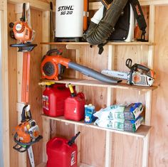 the inside of a shed with various tools and supplies on shelves, including chainsaws